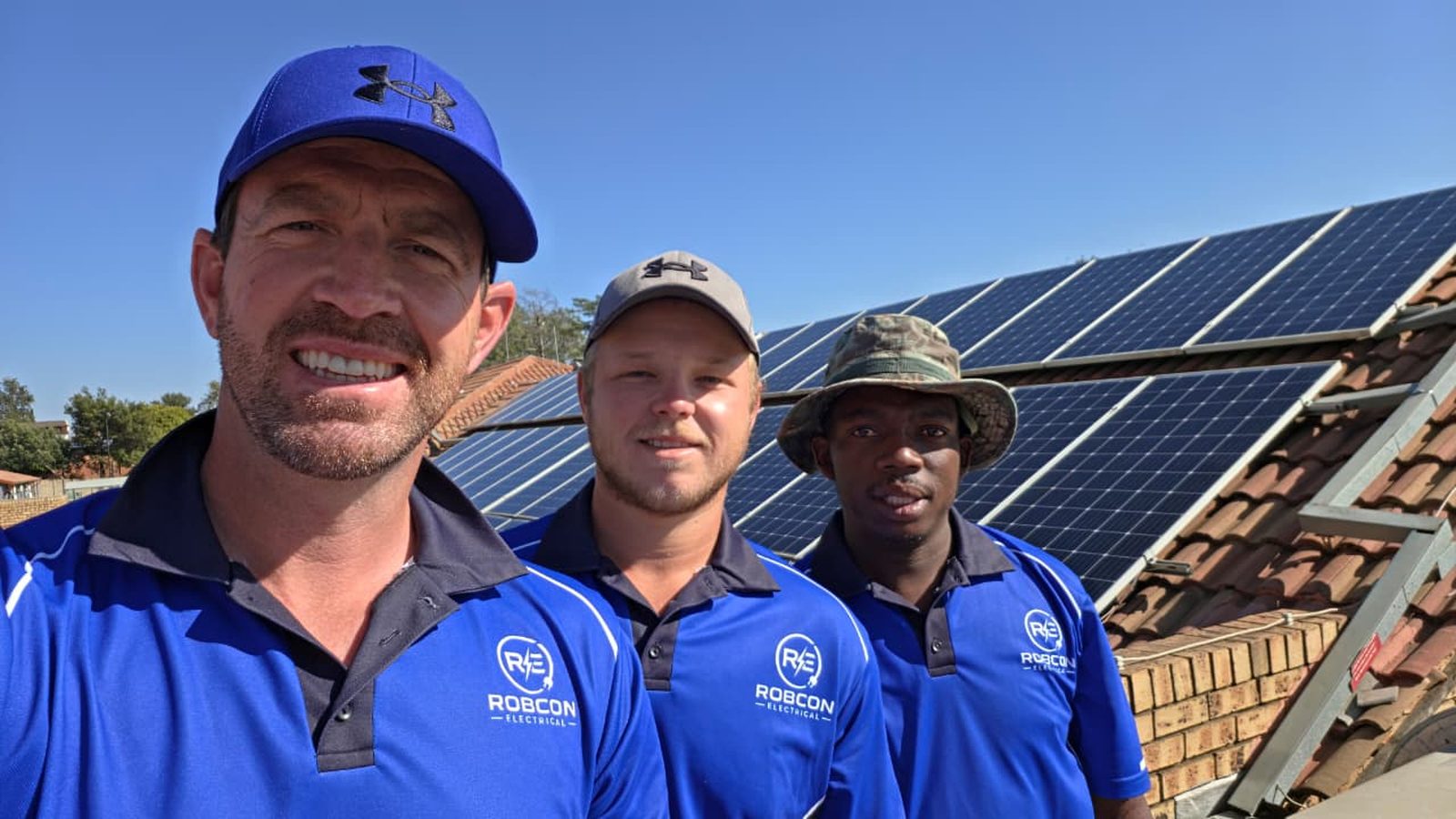 The three-man RobCon Electrical solar cleaning crew on a Pretoria rooftop